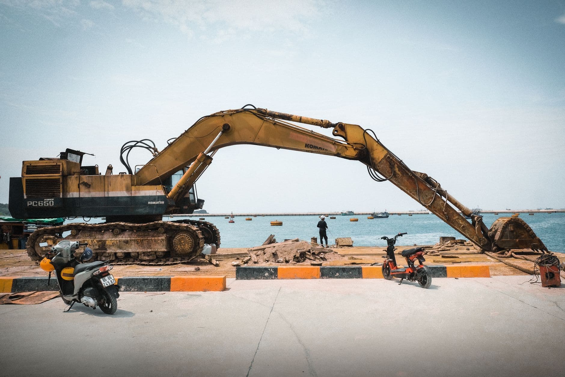 Tracked excavator at a waterfront construction site
